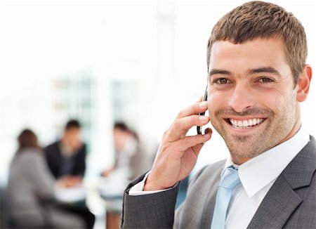 simsearch:400-04113098,k - Handsome businessman on the phone in the foreground while his team is working in the office Stock Photo - Budget Royalty-Free & Subscription, Code: 400-04267348