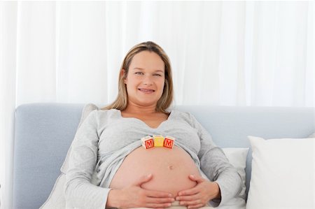 simsearch:400-04176771,k - Portrait of a pregnant woman having mom letters on her belly at home Stock Photo - Budget Royalty-Free & Subscription, Code: 400-04267368