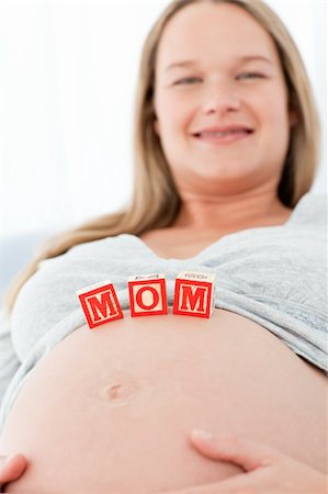 simsearch:400-04266869,k - Close up of a woman having mom letters on her belly lying on a bed at home Stock Photo - Budget Royalty-Free & Subscription, Code: 400-04267399