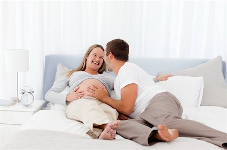 Smiling future parents liyng on the bed Stock Photo - Budget Royalty-Free & Subscription, Code: 400-04267438