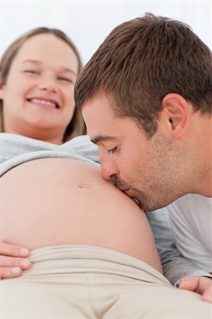 simsearch:400-04266840,k - Happy man kissing the belly of his pregnant wife while relaxing in the bedroom Photographie de stock - Aubaine LD & Abonnement, Code: 400-04267455