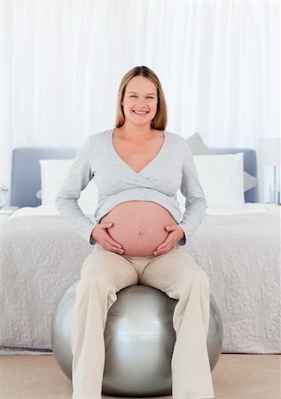 simsearch:400-04266869,k - Pretty future mother sitting on a fitness ball and touching her belly in the bedroom Stock Photo - Budget Royalty-Free & Subscription, Code: 400-04267464