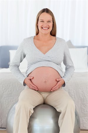 simsearch:400-04266869,k - Front view of a happy future mom sitting on a fitness ball and looking at the camera Stock Photo - Budget Royalty-Free & Subscription, Code: 400-04267462