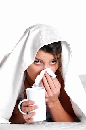 A portrait of a young woman in bed with a cold over white background Stock Photo - Budget Royalty-Free & Subscription, Code: 400-04268877