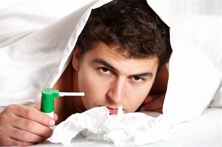 A portrait of a young man in bed with sore throat over white background Stock Photo - Budget Royalty-Free & Subscription, Code: 400-04268879