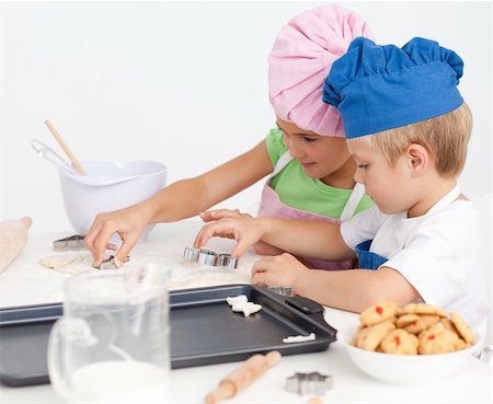 Two adorable children making biscuits together in the kitchen Stock Photo - Budget Royalty-Free & Subscription, Code: 400-04268958