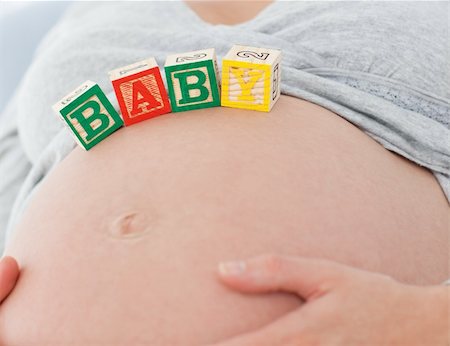 simsearch:400-04266869,k - Portrait of a future mom with baby letters on her belly and smiling at the camera Stock Photo - Budget Royalty-Free & Subscription, Code: 400-04268963