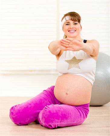 Smiling beautiful pregnant woman making gymnastics  at home Stock Photo - Budget Royalty-Free & Subscription, Code: 400-04269088