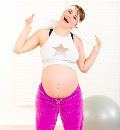 Energetic  beautiful pregnant woman enjoying making sports at home Stock Photo - Budget Royalty-Free & Subscription, Code: 400-04269094