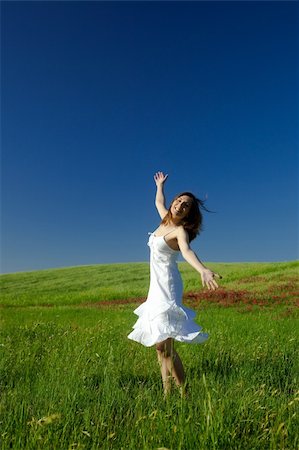 Beautiful happy young woman dancing on the field Stock Photo - Budget Royalty-Free & Subscription, Code: 400-04269140