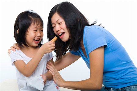 Little girl feeding her mum cone ice-cream. Stock Photo - Budget Royalty-Free & Subscription, Code: 400-04269457