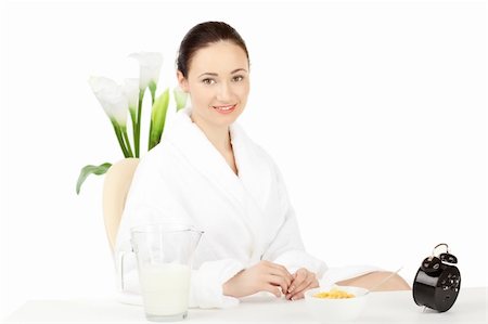 simsearch:400-08977333,k - Happy woman in bathrobe  for breakfast over white Stock Photo - Budget Royalty-Free & Subscription, Code: 400-04269829