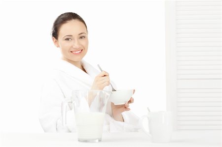 simsearch:400-08977333,k - Happy woman in bathrobe  for breakfast over white Stock Photo - Budget Royalty-Free & Subscription, Code: 400-04269830