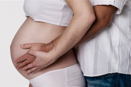 simsearch:400-08529613,k - Pregnant woman and her partner with their hands holding the belly Stock Photo - Budget Royalty-Free & Subscription, Code: 400-04261399