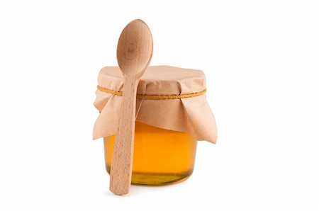 Honey in jar, spoon, isolated white. Stockbilder - Microstock & Abonnement, Bildnummer: 400-04261576