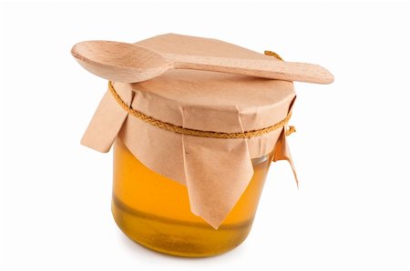 Honey in jar, wooden spoon, close up, isolated. Stockbilder - Microstock & Abonnement, Bildnummer: 400-04261577