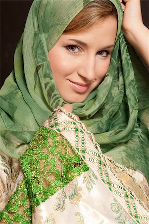 simsearch:400-08785263,k - Young Arab woman with veil close-up portrait on dark background Photographie de stock - Aubaine LD & Abonnement, Code: 400-04262292