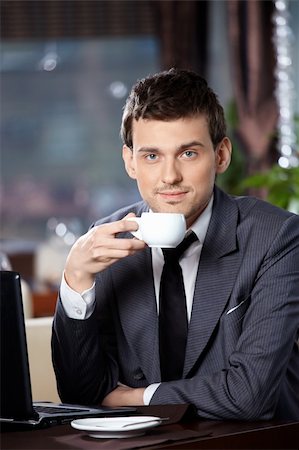 simsearch:400-04322314,k - Business man with the laptop drinks coffee in cafe Stock Photo - Budget Royalty-Free & Subscription, Code: 400-04262838