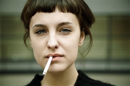real young woman smokes on the street, selective focus Stock Photo - Budget Royalty-Free & Subscription, Code: 400-04262900