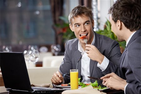 simsearch:400-04322314,k - Two smiling business men eat at restaurant Stock Photo - Budget Royalty-Free & Subscription, Code: 400-04262959
