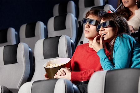 The couple with pop-corn looks cinema in 3d Stock Photo - Budget Royalty-Free & Subscription, Code: 400-04263005