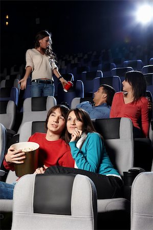 Young people look cinema at a cinema Stock Photo - Budget Royalty-Free & Subscription, Code: 400-04263007