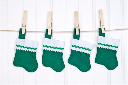 socks hanging clothesline - Holiday Stockings Hanging on a Clothesline on a White Background. Stock Photo - Budget Royalty-Free & Subscription, Code: 400-04263177