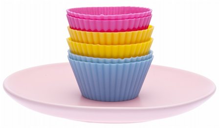simsearch:614-03903060,k - Stack of vibrant cupcake wrappers on a pastel colored plate.  Isolated on white with a clipping path. Photographie de stock - Aubaine LD & Abonnement, Code: 400-04263483