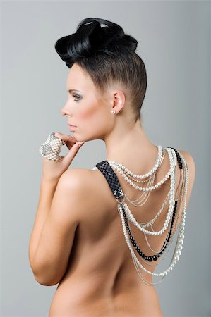 simsearch:400-04209471,k - back side portrait of sensual brunette with creative hair style covering her naked shoulder with lots of necklace Photographie de stock - Aubaine LD & Abonnement, Code: 400-04274999