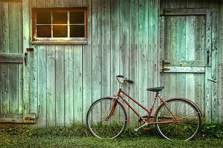 Old bicycle leaning against grungy barn Stock Photo - Budget Royalty-Free & Subscription, Code: 400-04275430