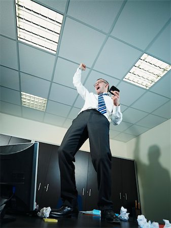 simsearch:400-04164036,k - mature business man standing on desk and screaming for joy. Vertical shape, full length, copy space Foto de stock - Super Valor sin royalties y Suscripción, Código: 400-04275617