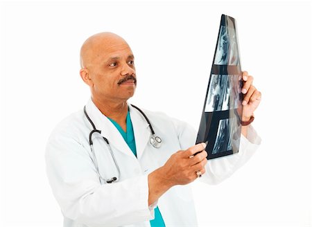 simsearch:400-05088218,k - Handsome african-american doctor examines a patient's x-rays.  Isolated on white. Stock Photo - Budget Royalty-Free & Subscription, Code: 400-04275697