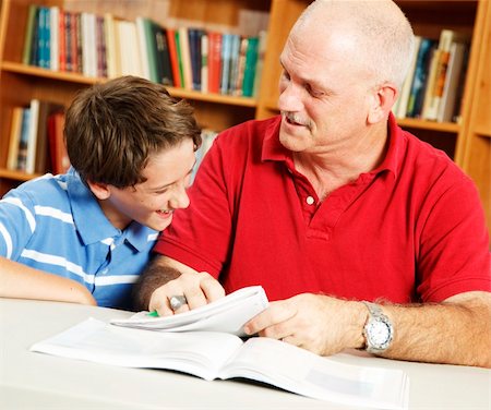 simsearch:400-04477480,k - Little boy and his teacher or father in the library doing homework and laughing together. Photographie de stock - Aubaine LD & Abonnement, Code: 400-04275700