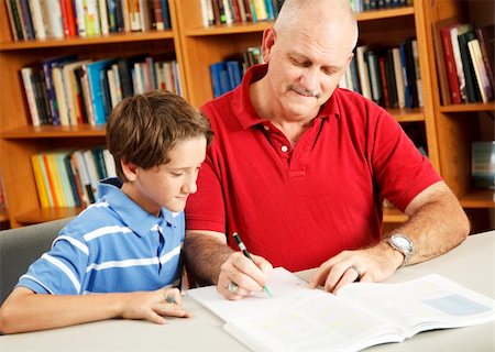 simsearch:400-05751679,k - Father helping his young son do homework at the library. Stock Photo - Budget Royalty-Free & Subscription, Code: 400-04276108