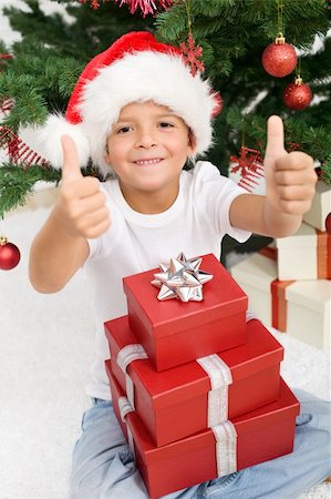 simsearch:400-06477682,k - Boy having lots of christmas presents showing thumbs up sign with both hands Stock Photo - Budget Royalty-Free & Subscription, Code: 400-04276231