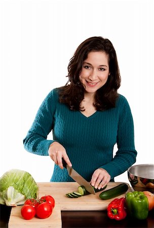 Beautiful woman cutting cucumber in kitchen, cooking and preparing to make a salad, isolated. Stock Photo - Budget Royalty-Free & Subscription, Code: 400-04276613