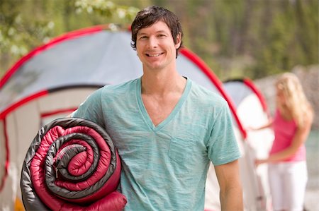 sleep in camper - A portrait of a happy male camper holding a sleeping bag Stock Photo - Budget Royalty-Free & Subscription, Code: 400-04276667