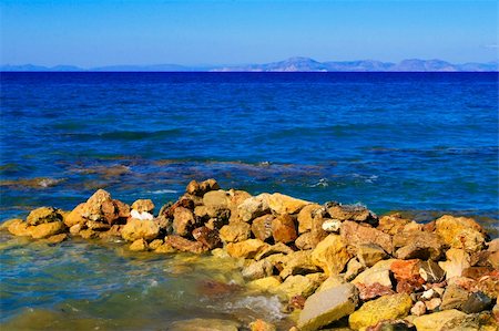 simsearch:851-02960085,k - Stones on the Aegean coast and the mountains far away Stock Photo - Budget Royalty-Free & Subscription, Code: 400-04277312