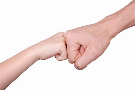 Two fists - children's and man's - on a white background Stock Photo - Budget Royalty-Free & Subscription, Code: 400-04277433