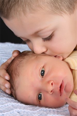 Blond boy with his newborn baby brother Stock Photo - Budget Royalty-Free & Subscription, Code: 400-04277929