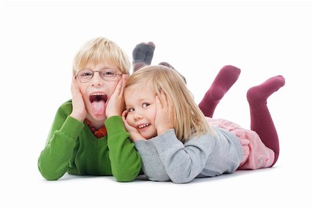 portrait of two young siblings looking at camera, making faces- isolated on white Stock Photo - Budget Royalty-Free & Subscription, Code: 400-04278289