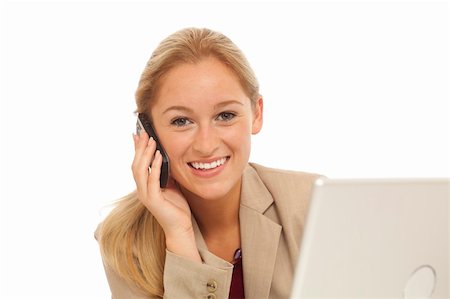 simsearch:400-05732500,k - Portrait of young business girl using cell phone at desk with laptop Foto de stock - Royalty-Free Super Valor e Assinatura, Número: 400-04278575