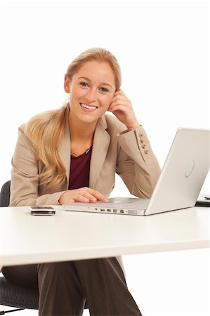 simsearch:400-05732500,k - Young business girl sitting at desk with laptop Foto de stock - Royalty-Free Super Valor e Assinatura, Número: 400-04278572