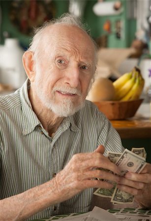 simsearch:400-04744719,k - Senior man at home with a few dollars counting his money Stock Photo - Budget Royalty-Free & Subscription, Code: 400-04278916