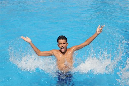 boy teenager splashing water open arms blue swimming pool Fotografie stock - Microstock e Abbonamento, Codice: 400-04279672