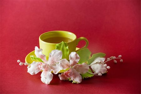 simsearch:400-04232483,k - The cup of green tea with caramel orchid on red background Stock Photo - Budget Royalty-Free & Subscription, Code: 400-04279781