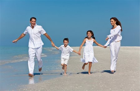 simsearch:400-04235471,k - A happy family of mother, father and two children, son and daughter, running holding hands and having fun in the sand of a sunny beach Stock Photo - Budget Royalty-Free & Subscription, Code: 400-04270247