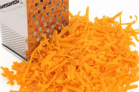 Grated red leicester cheddar cheese, with stainless steel grater, over white background. Stock Photo - Budget Royalty-Free & Subscription, Code: 400-04270282