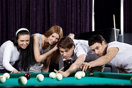 pool ball girls - Young attractive people aim at game at billiards Stock Photo - Budget Royalty-Free & Subscription, Code: 400-04271212