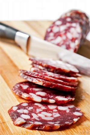 simsearch:400-04745282,k - Salami sliced on chopping board isolated on white Stock Photo - Budget Royalty-Free & Subscription, Code: 400-04271292